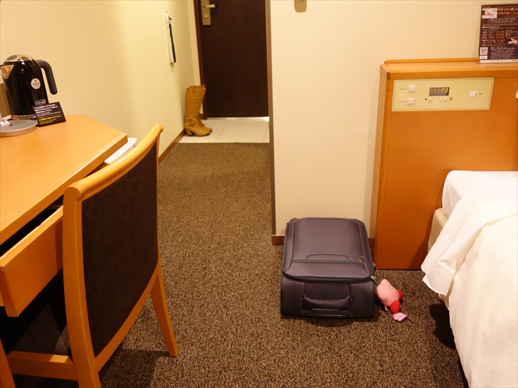 ホテルの客室でスーツケースを置くところ